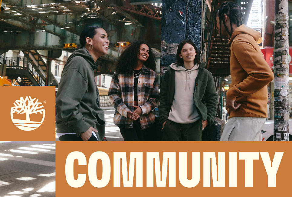 A group of people in Timberland clothing under an elevated train track, with the headline 'COMMUNITY'