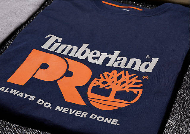 Image of t-shirts in gray, blue, brown and black with colorful Timberland PRO logos on the front