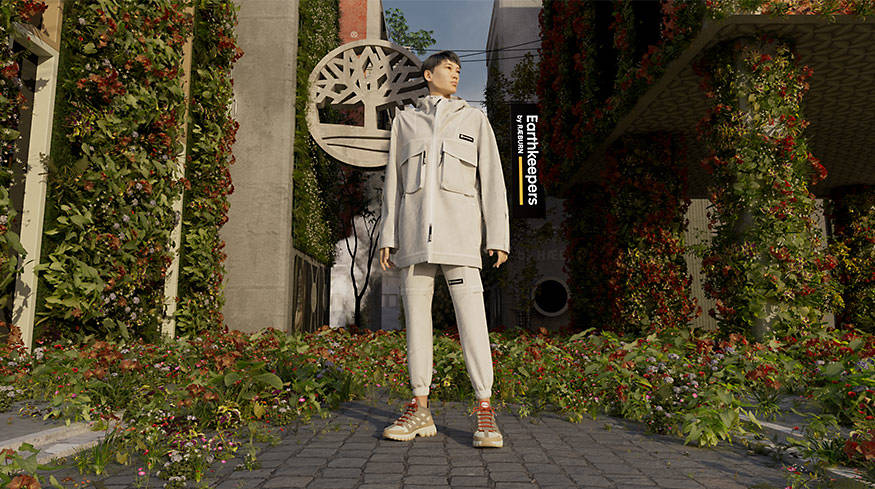 Man in tan sneakers with thick outdoor soles and orange laces, standing in an urban garden in off-white matching joggers and parka.