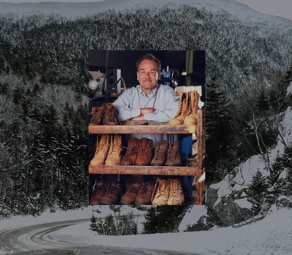 Image of Timberland's Sidney Swartz, a middle-aged man smiling and leaning against a rack of worn-out Timberland boots.
