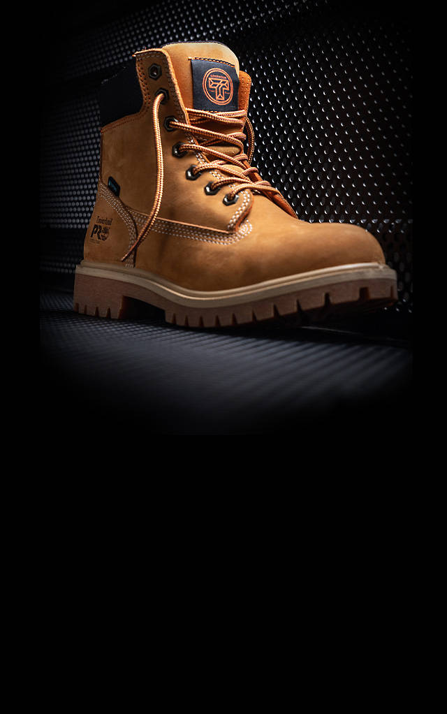 Close-up image of a wheat colored Timberland PRO work boot against a black background with the caption in white letters 'Working to Promote The Skilled Trades'