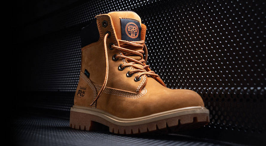 Image of a wheat Timberland work boot against a black background.