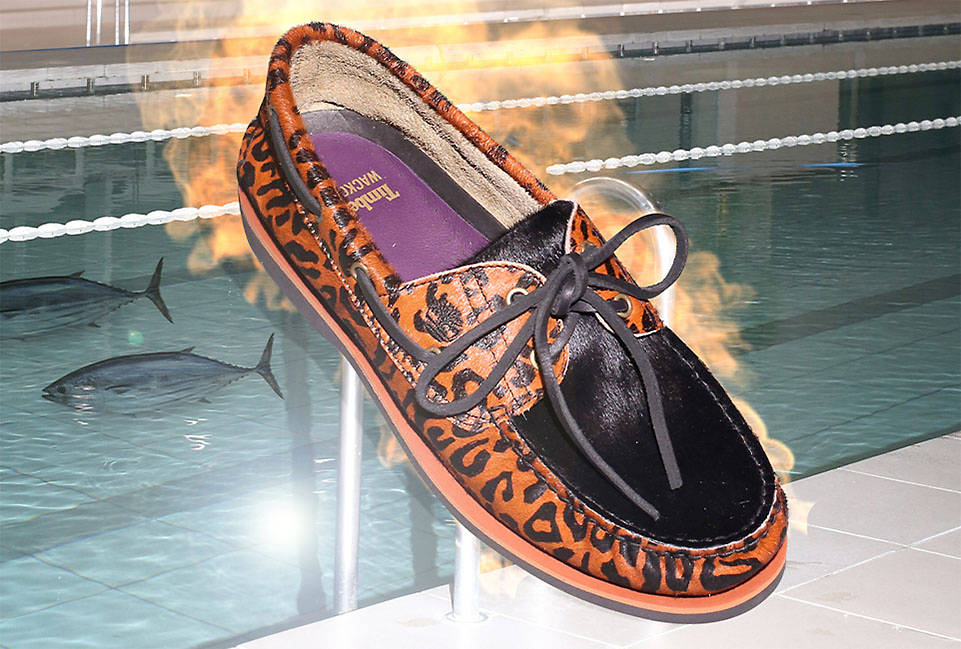 Image of a brown leopard print boat shoe with purple insole that's on fire, sailing through the air over a luxury in-ground pool with fish in it.