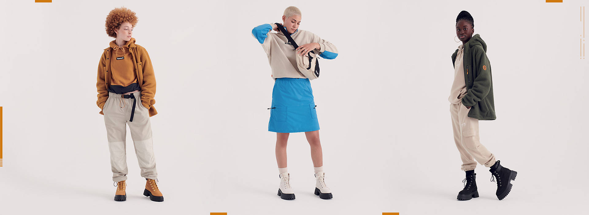 Image of a woman with cropped white-blond hair, wearing white platform boots with black outsoles, in a blue skirt and white/blue matching hoodie.