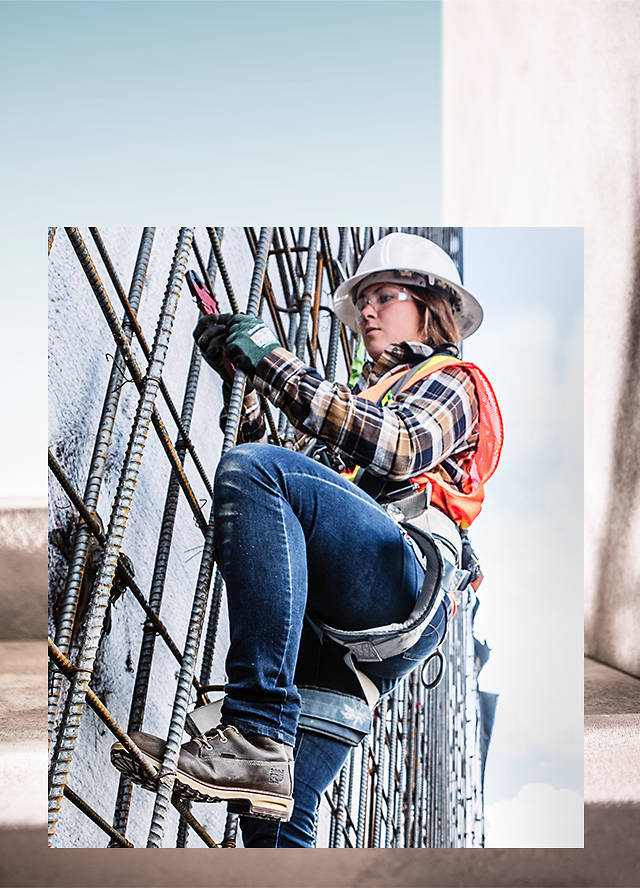 woman climbing scaffolding in boots