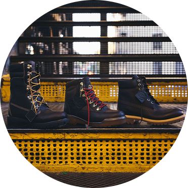 From left to right, an image of the Timberland Super Boot, Field Boot and 6-Inch Premium Boot on top of a stair on a New York City subway platform.