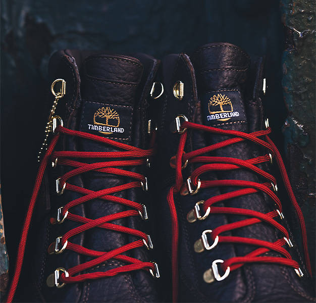 Front facing image of the Timberland Field Boot displaying the Timberland logo on the tongue and the red laces