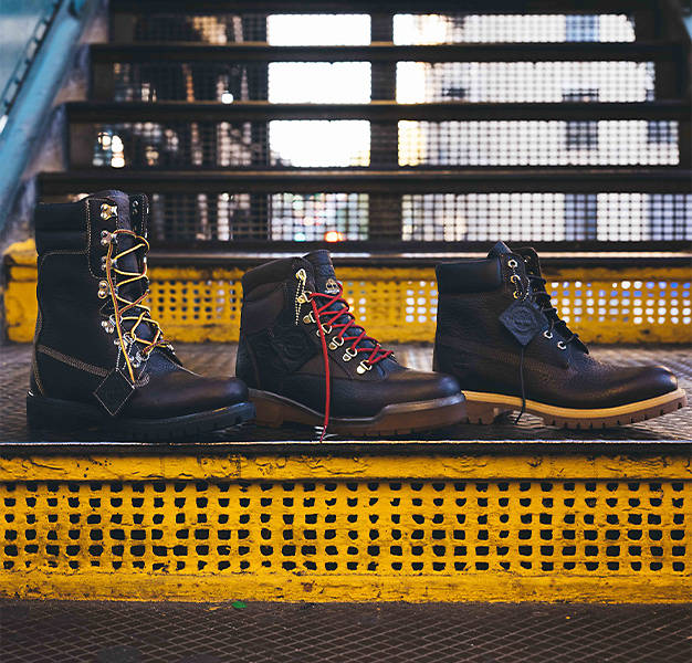 From left to right, an image of the Timberland Super Boot, Field Boot and 6-Inch Premium Boot on top of a stair of a New York City subway platform