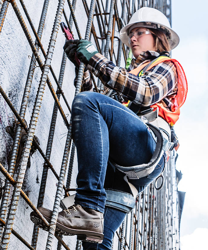 woman climbing scaffolding in boots